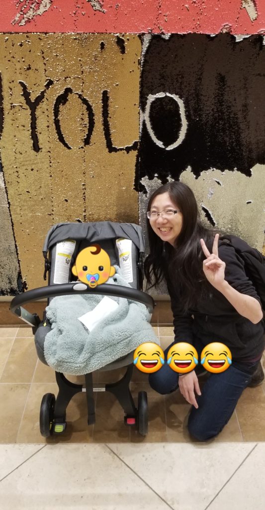 Mom blogger with Doona car seat with infant inside